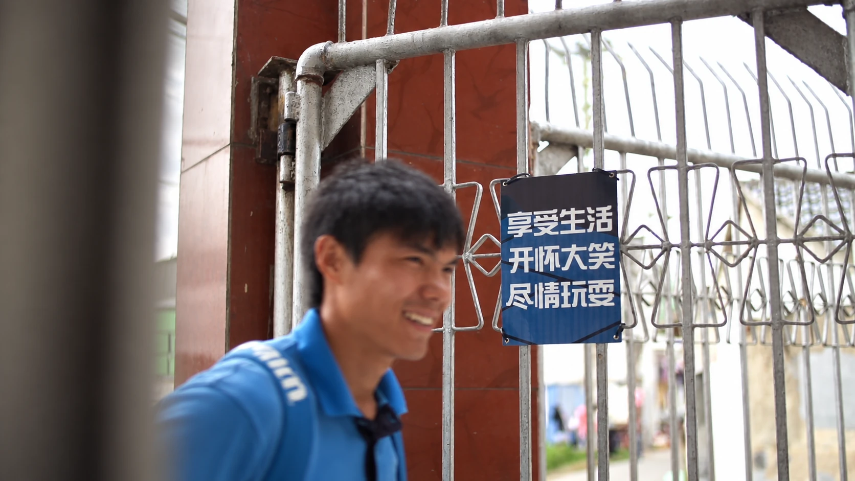 The coach walking through the school gate.