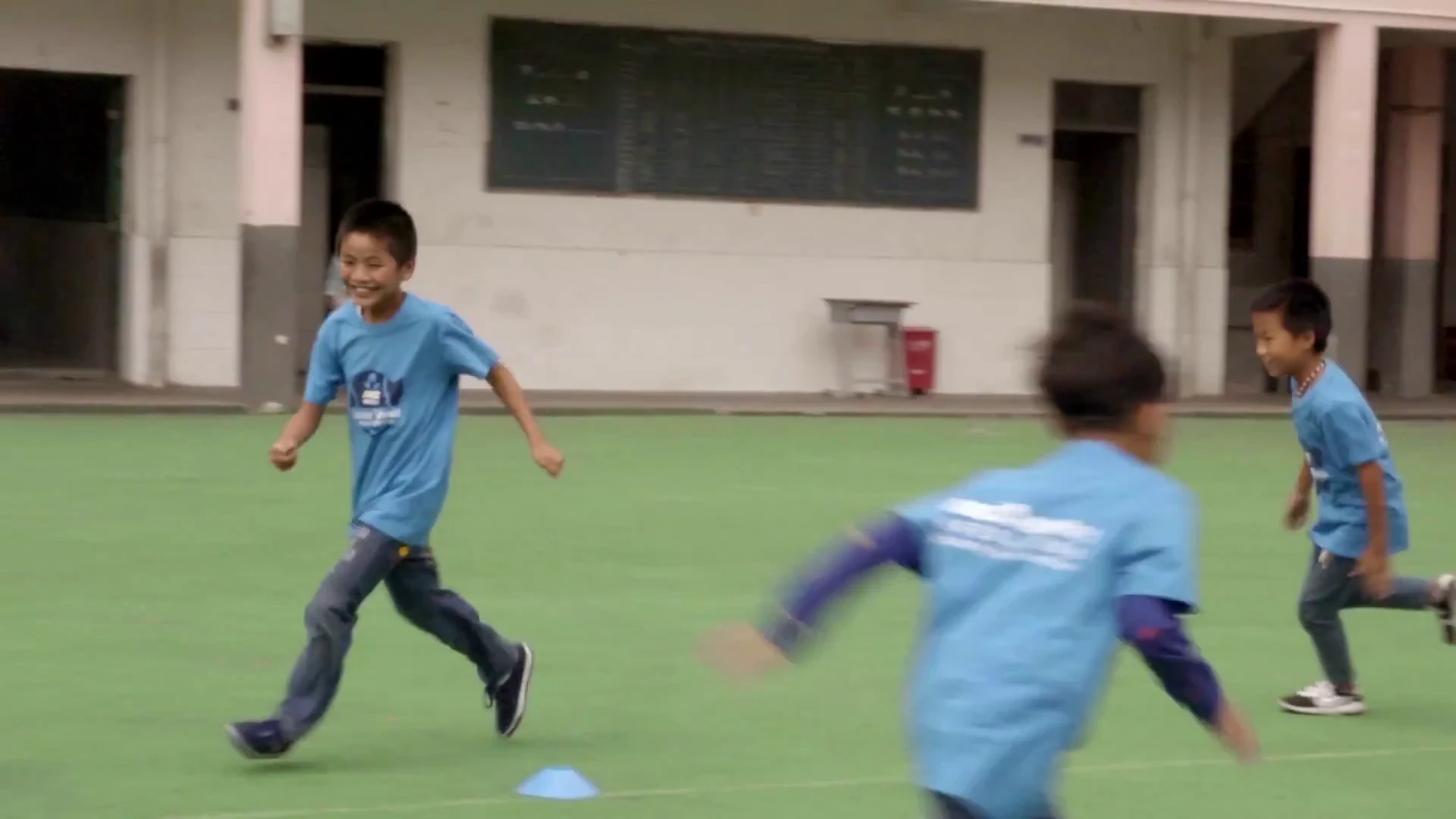 Junior participants running during a warm-up game.