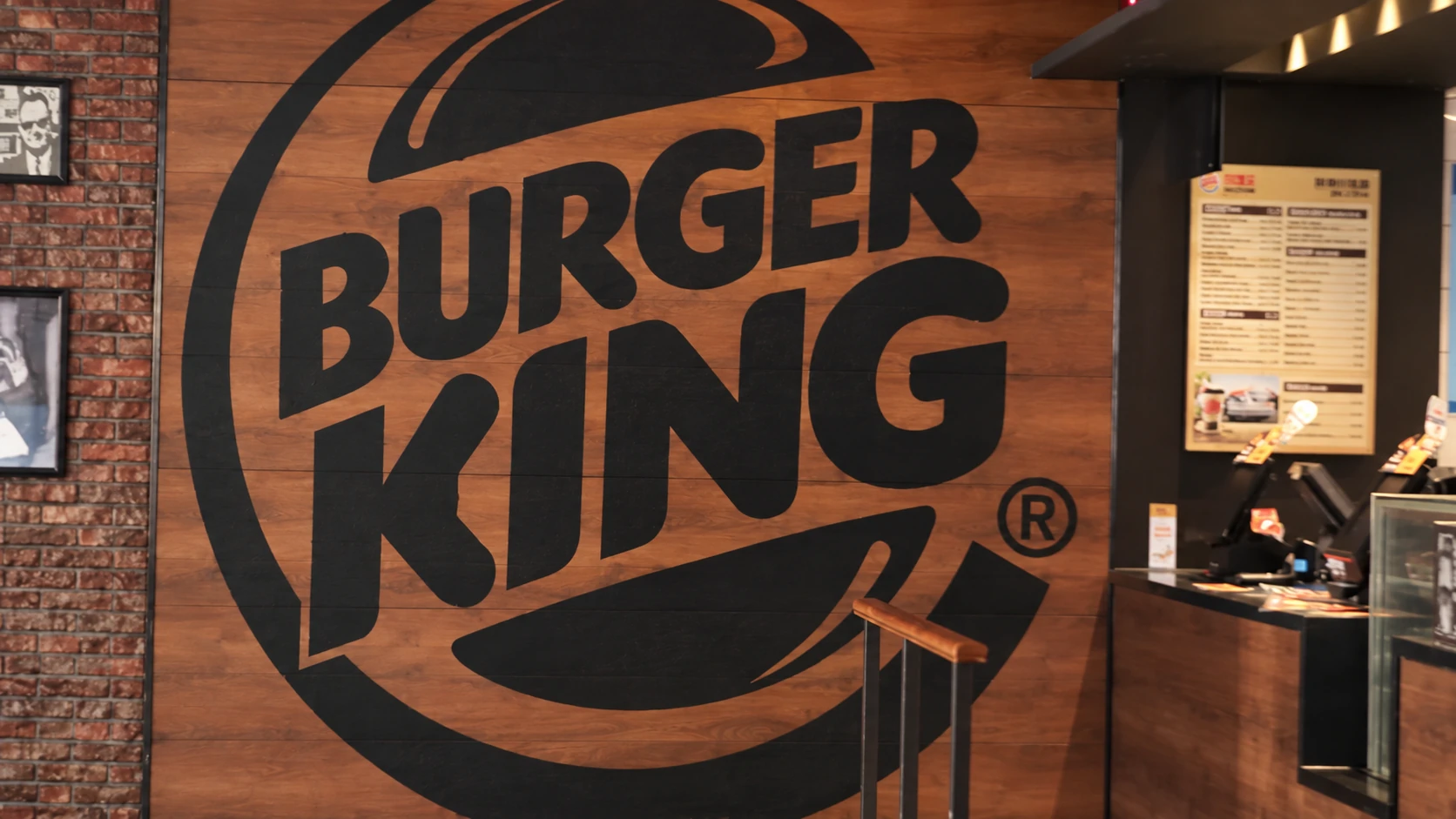 A large Burger King emblem painted on the restaurant wall.