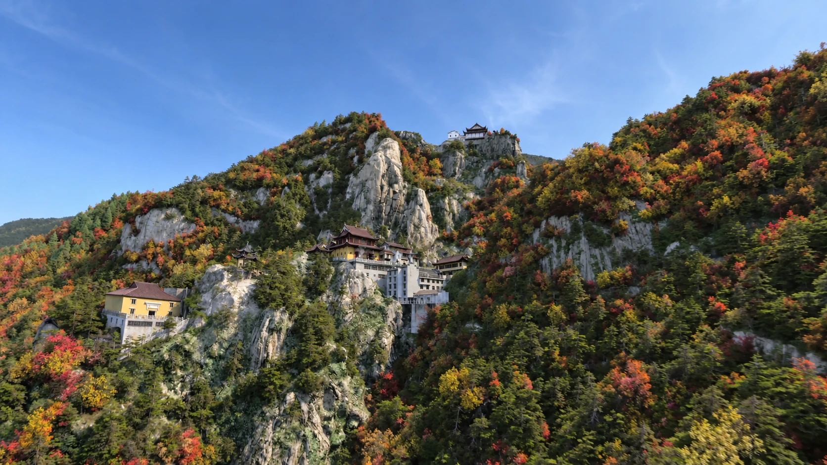 A monastery built against a cliff among autumn trees — AI-assisted still derived from Tippett Studio’s CG film.