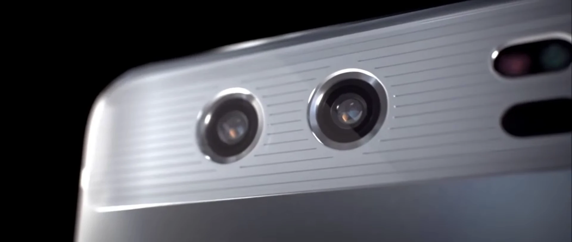 Close detail of the two rear camera lenses and metal finish of a Huawei smartphone.