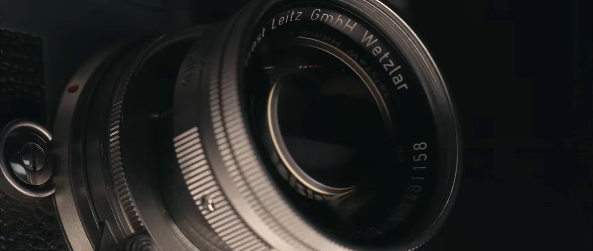Close detail of a camera lens in the film’s optics sequence.