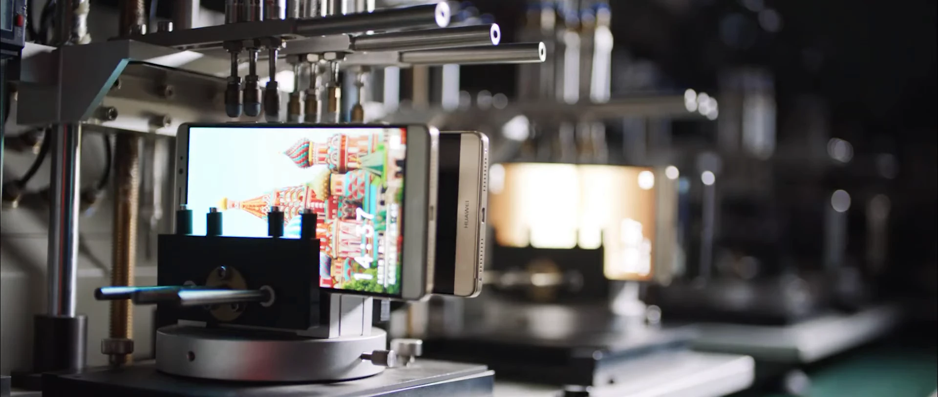 A smartphone screen displaying a city scene beneath testing equipment.