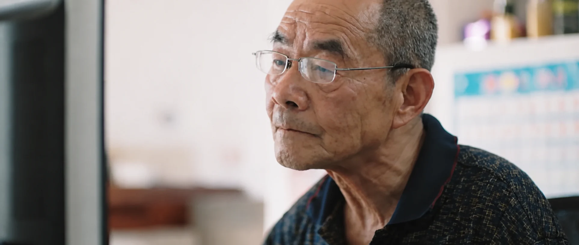 An older contributor seated for an interview.