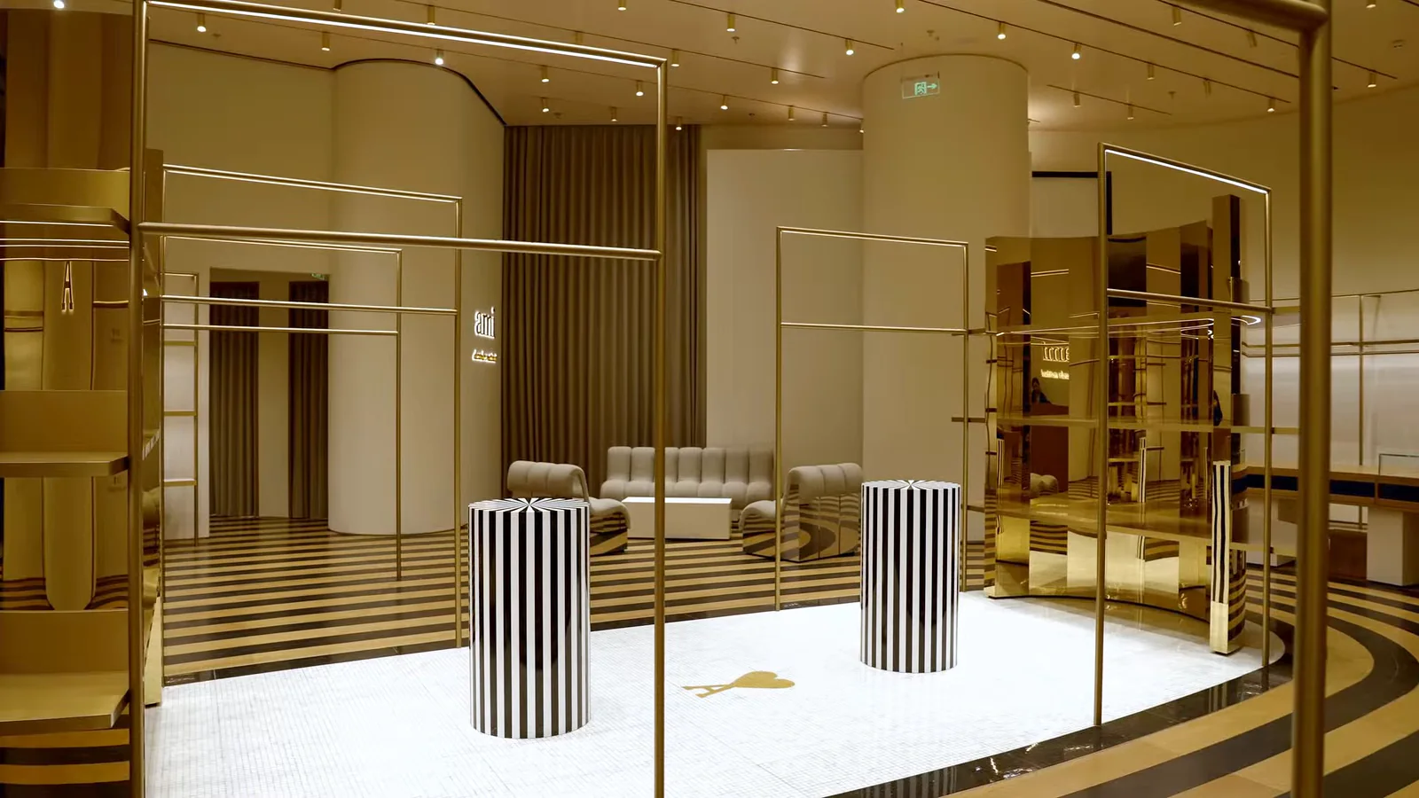 Warm-lit interior displays inside the AMI Paris Guangzhou flagship.