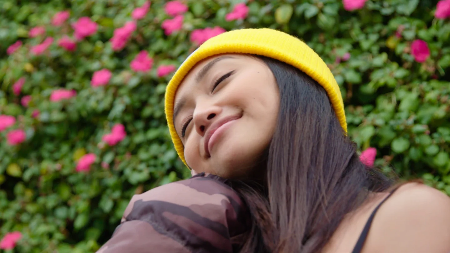 Close portrait of an event participant against a floral background