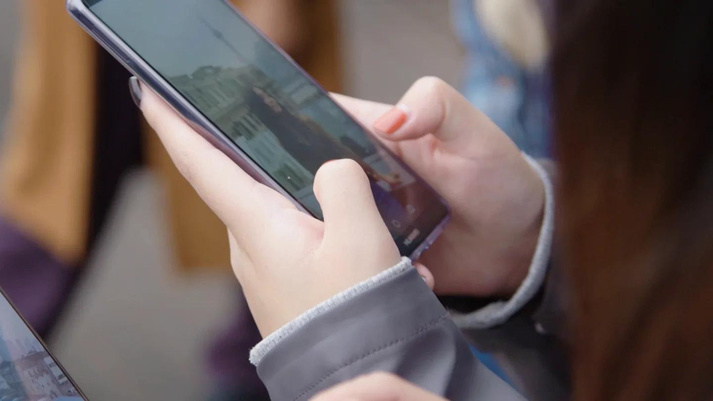Close view of a participant using a smartphone