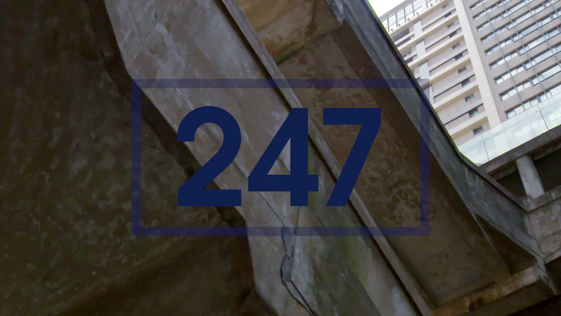 New Balance 247 title graphic over concrete architecture
