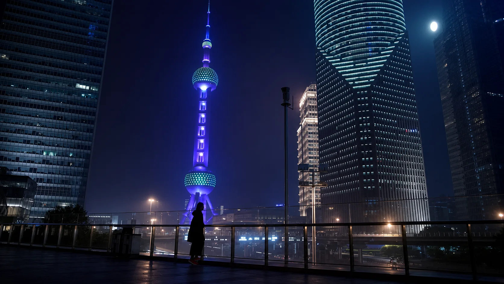 Jennifer Bin silhouetted near the illuminated Shanghai skyline at night