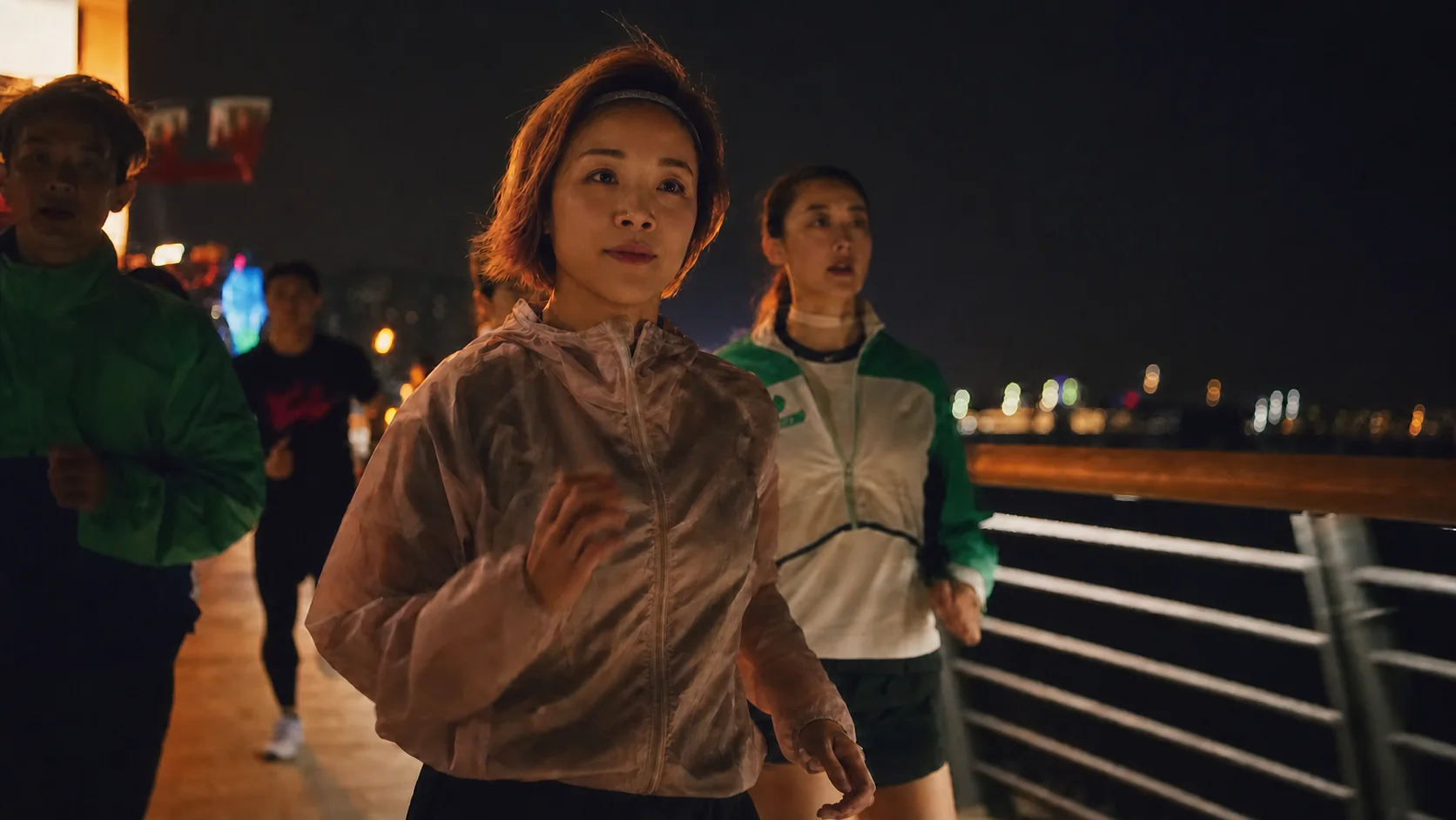 One Crew runner leading the group across a bridge at night