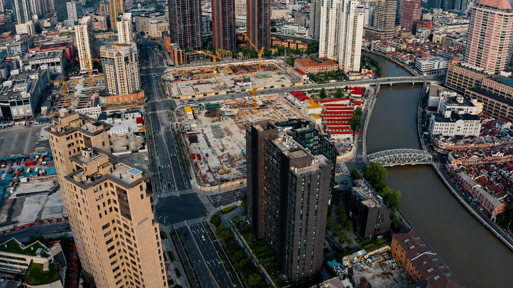 Aerial view over Suhe Creek with bridges, dense urban blocks and construction areas