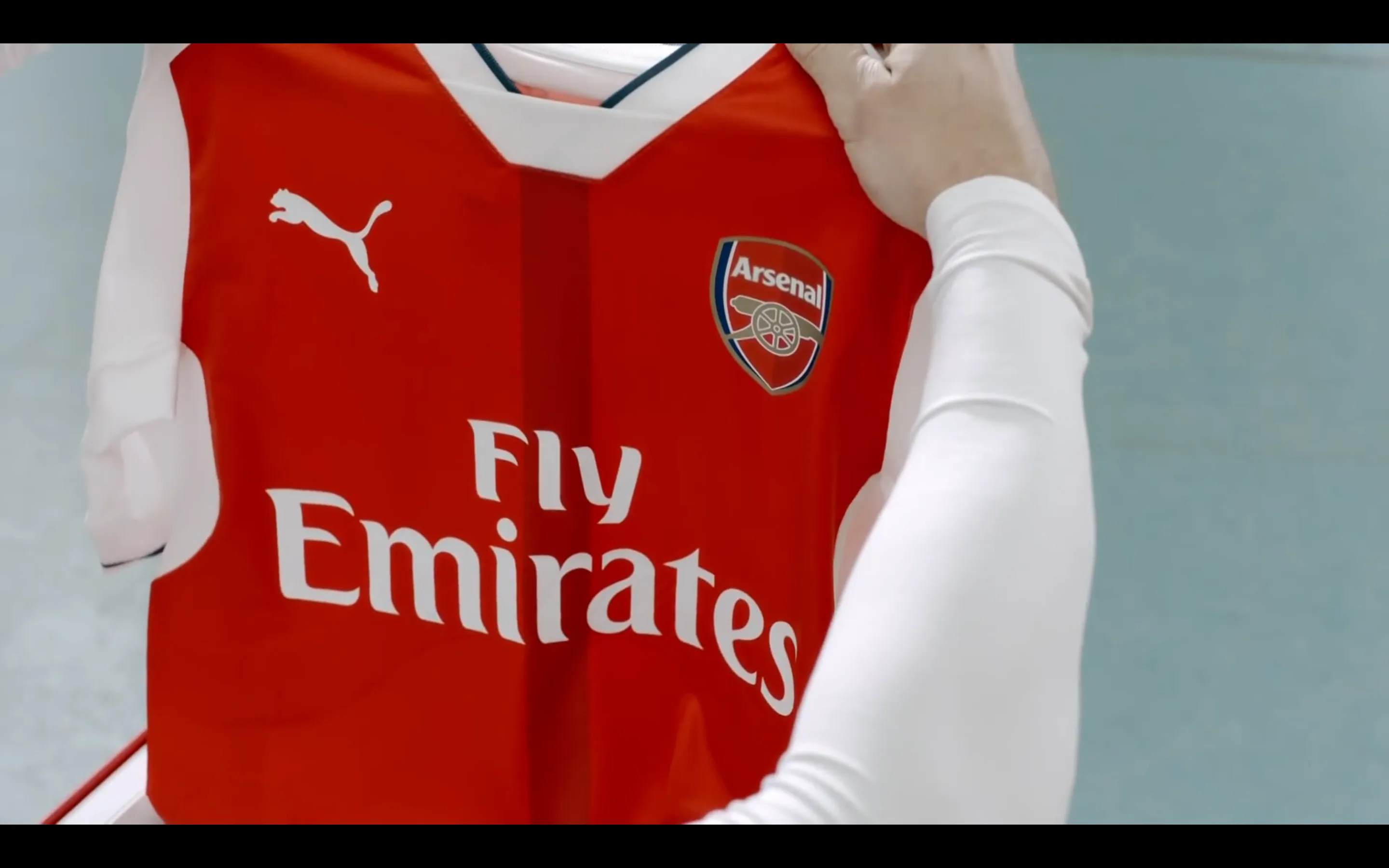 Close view of a red PUMA Arsenal home shirt prepared for filming