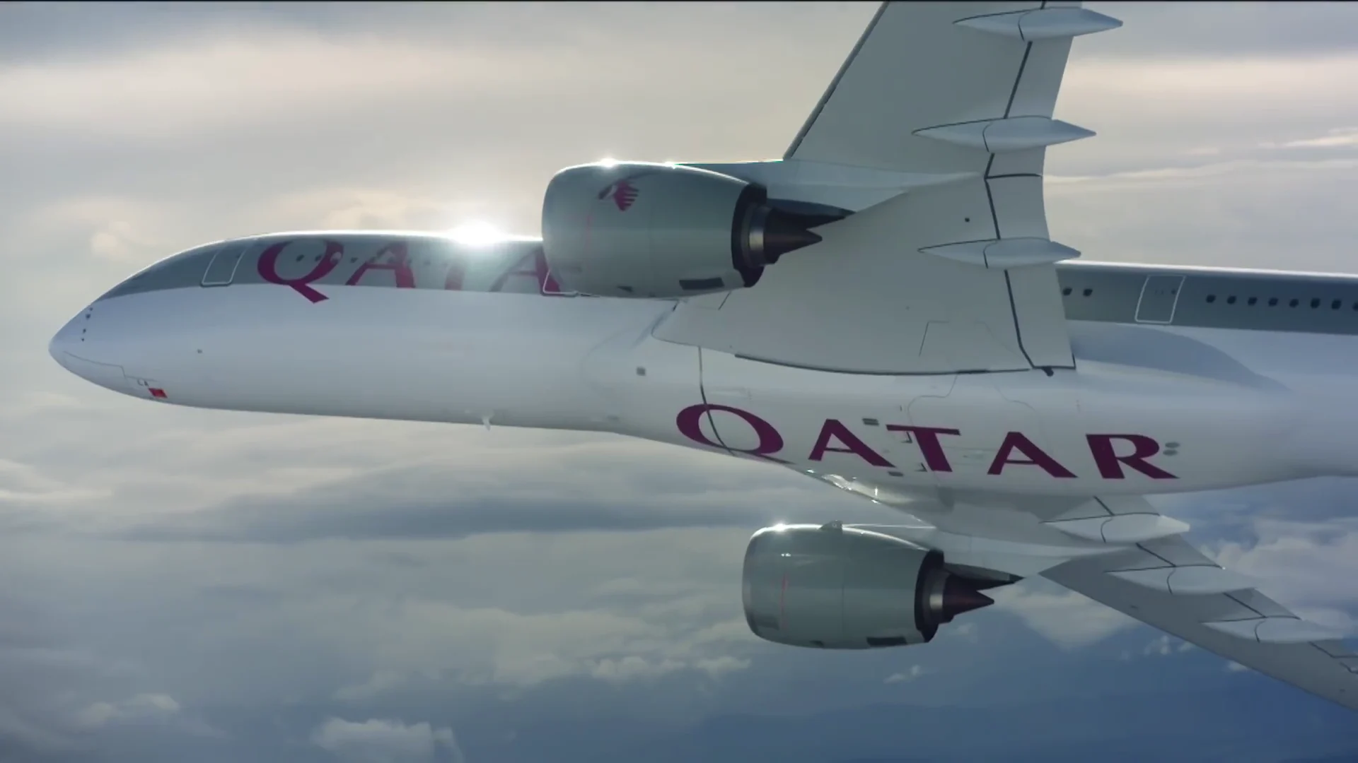 Qatar Airways aircraft flying above clouds in close view