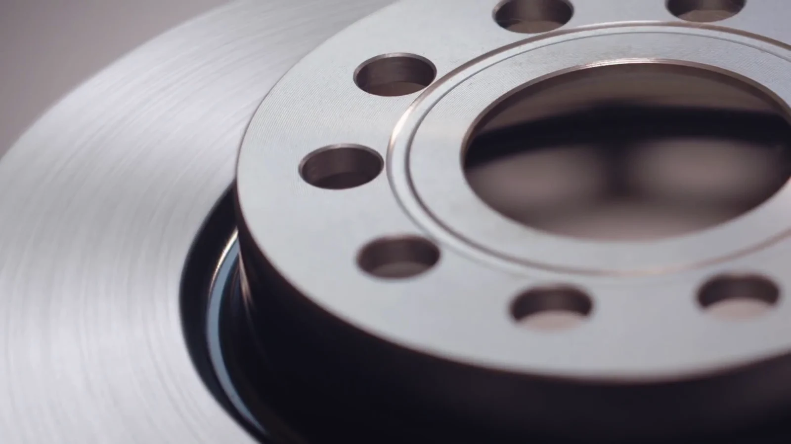 Close-up of the machined surface and mounting holes of a brake disc
