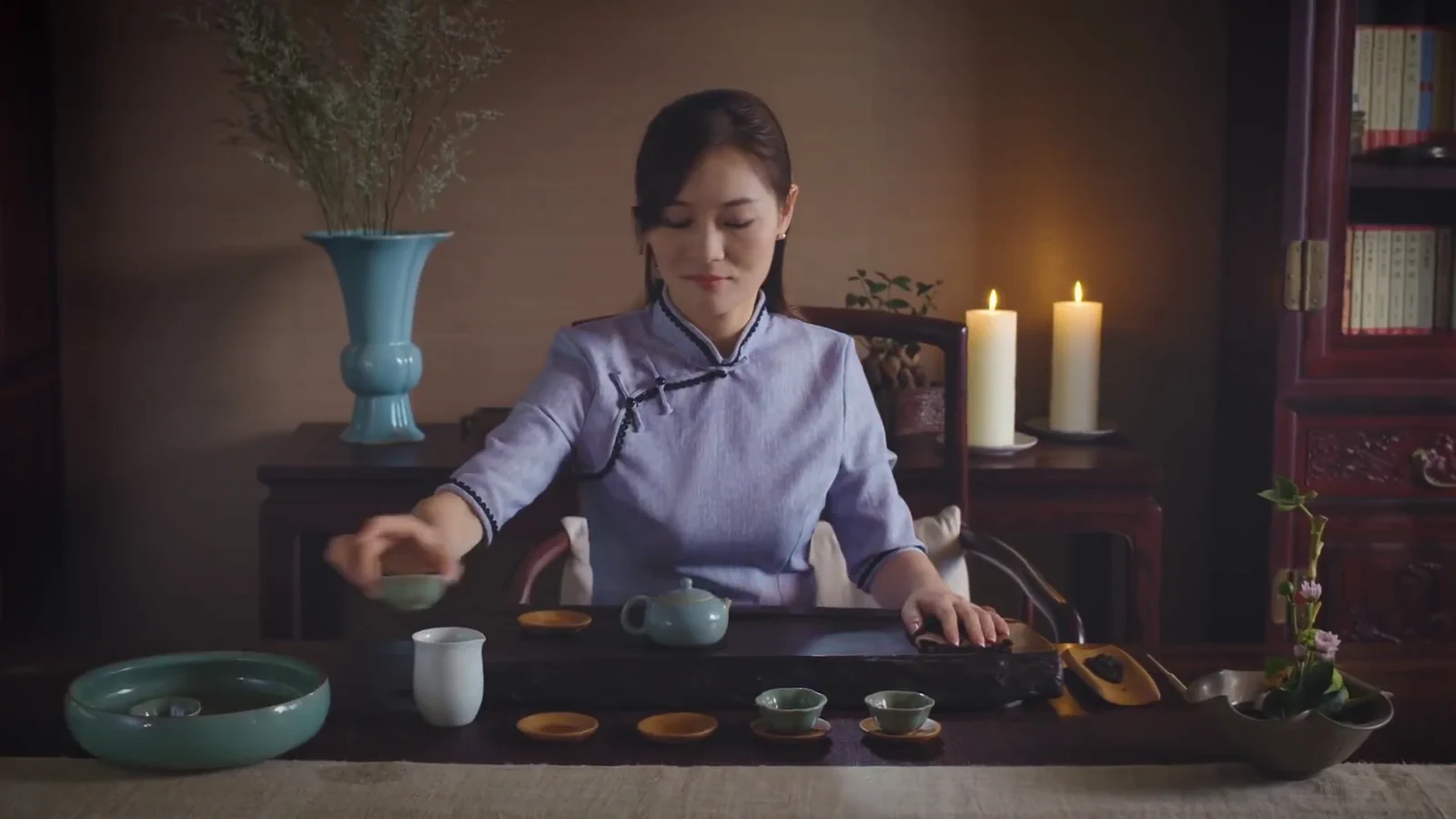 Woman serving tea in the staged tea-room setting for the TRW campaign