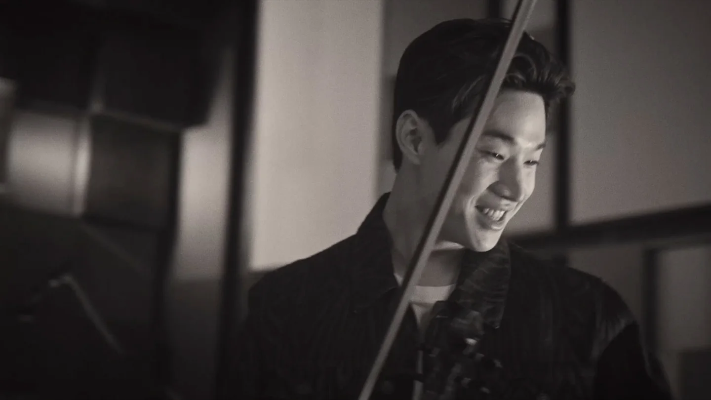 Henry Lau performs with a violin during the Tuborg Open production