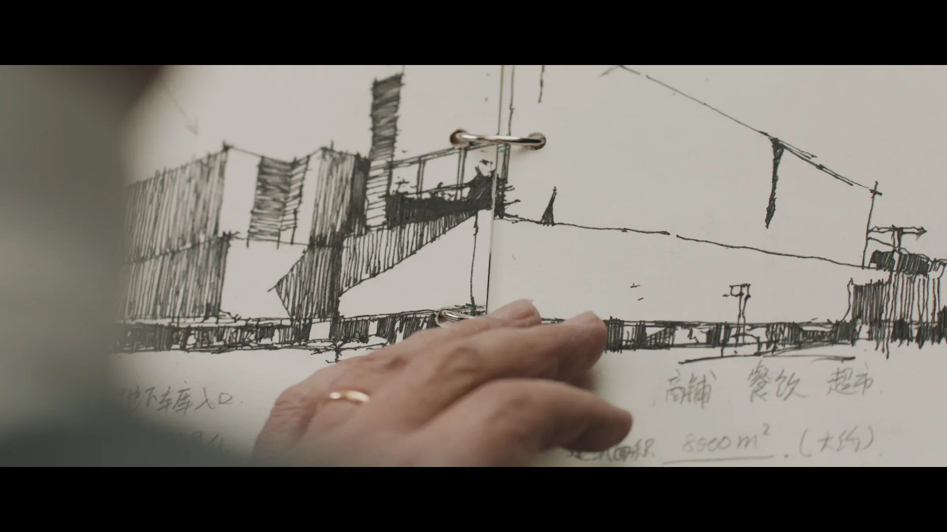 Close view of the architectural drawing inside the grandfather's sketchbook