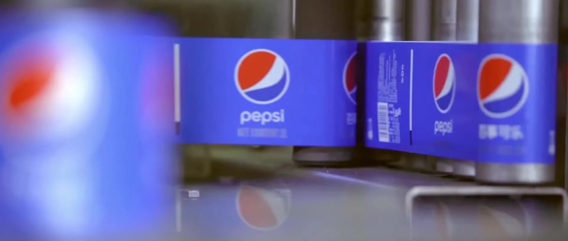 Pepsi labels moving through a bottling facility.