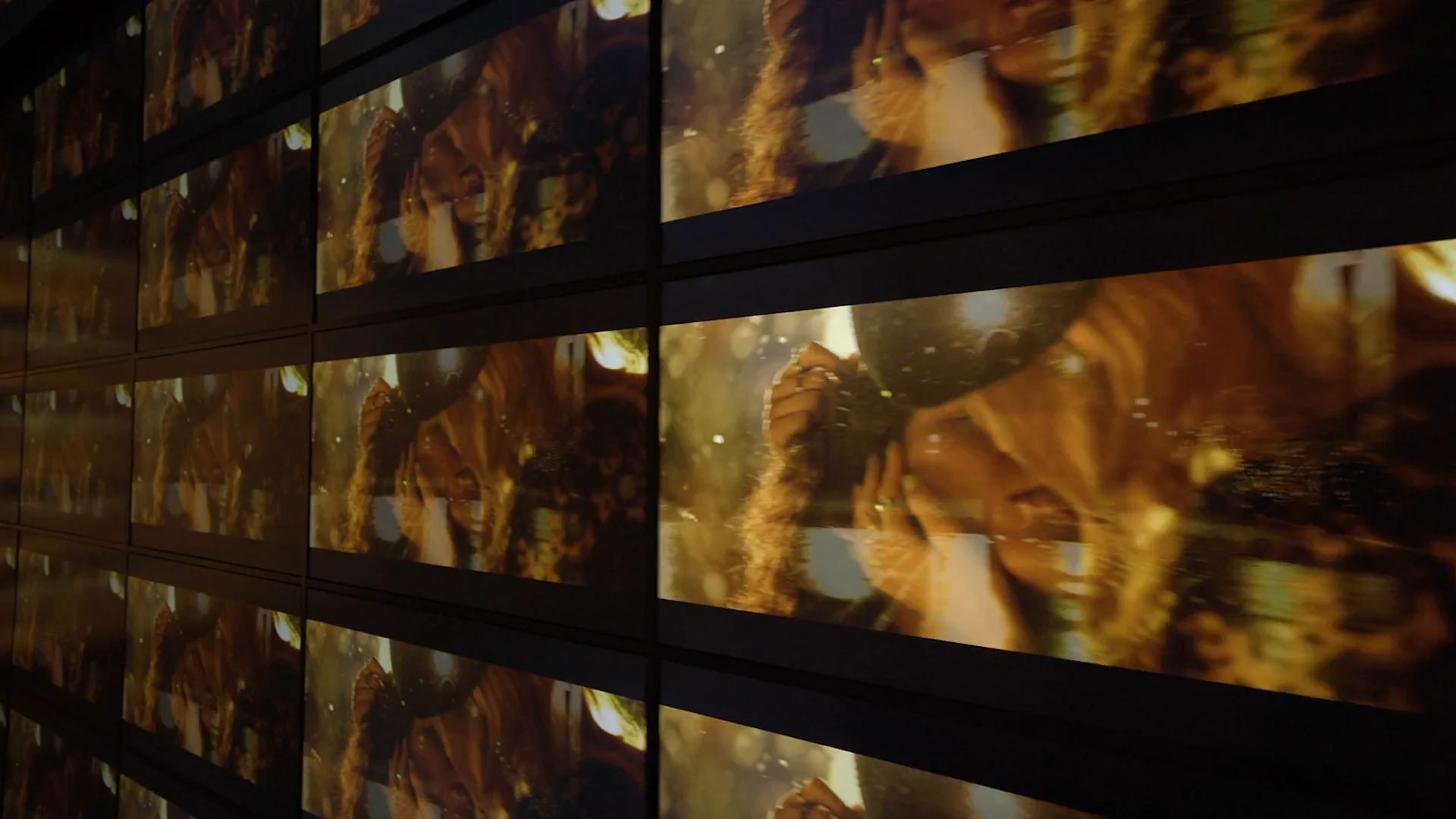 Screen reflections and imagery forming an immersive corridor.