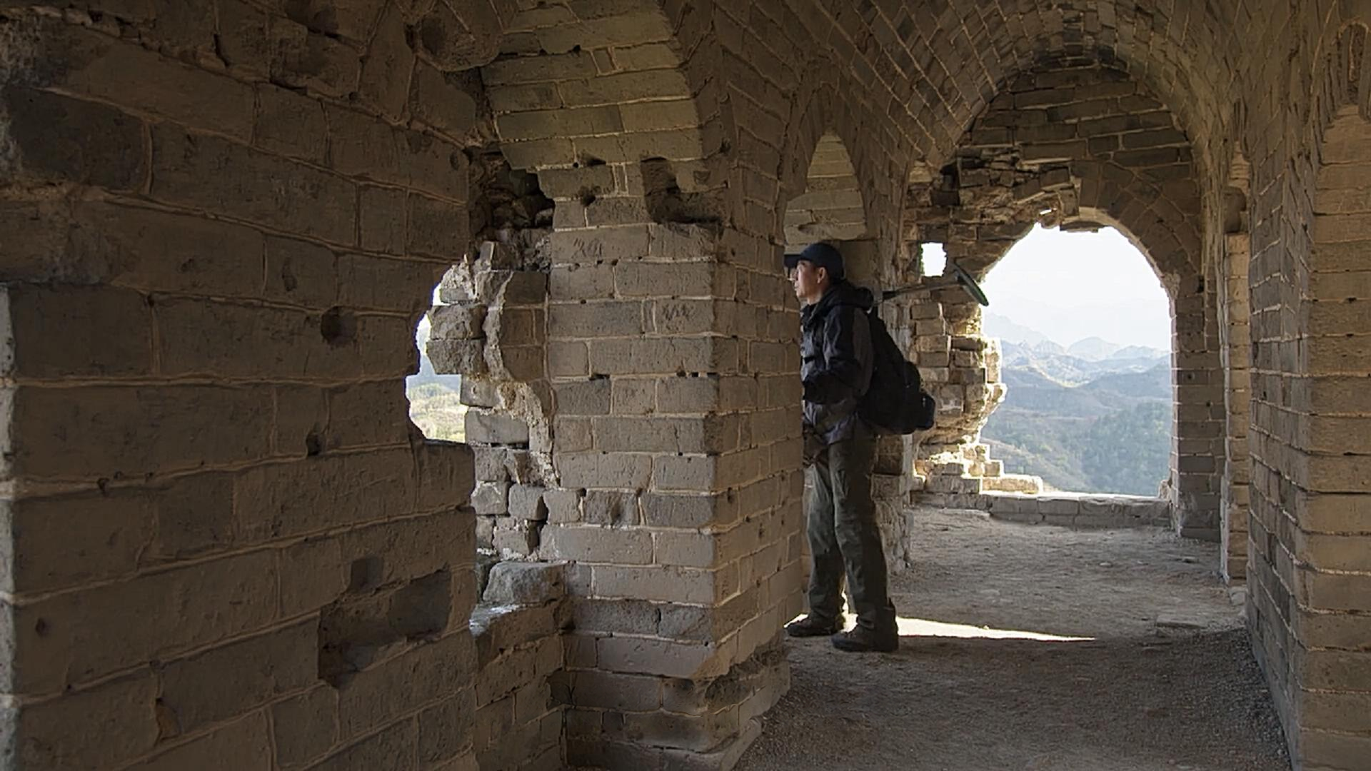 A visitor inside a weathered watchtower. Frame from the programme.