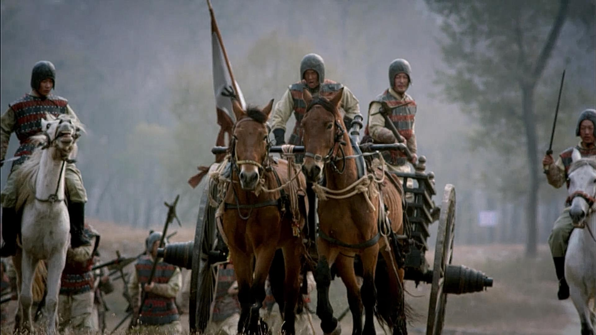 A chariot and mounted riders in a historical re-enactment.