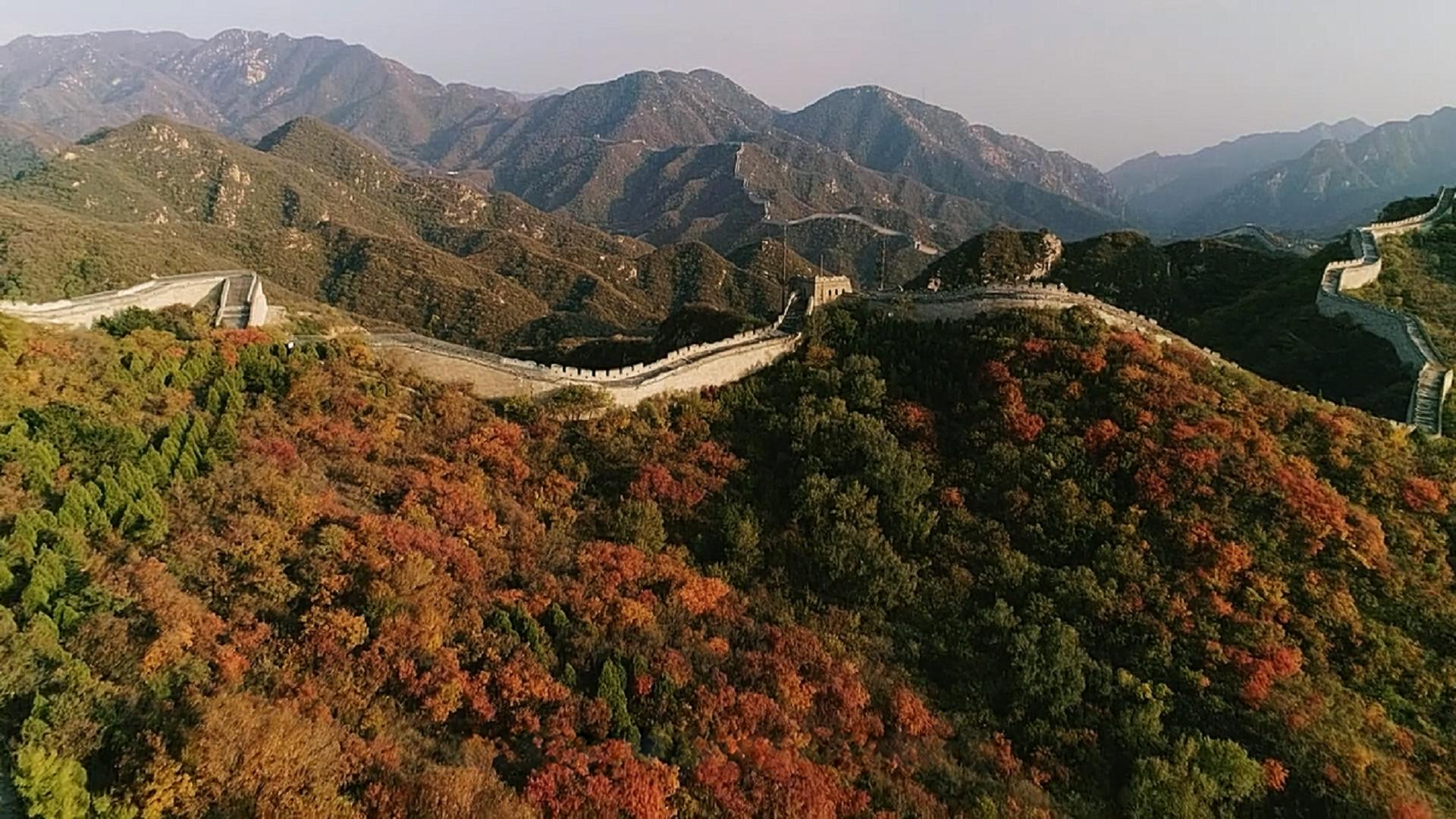 The Great Wall crossing an autumn mountain landscape.