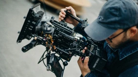 man with film camera