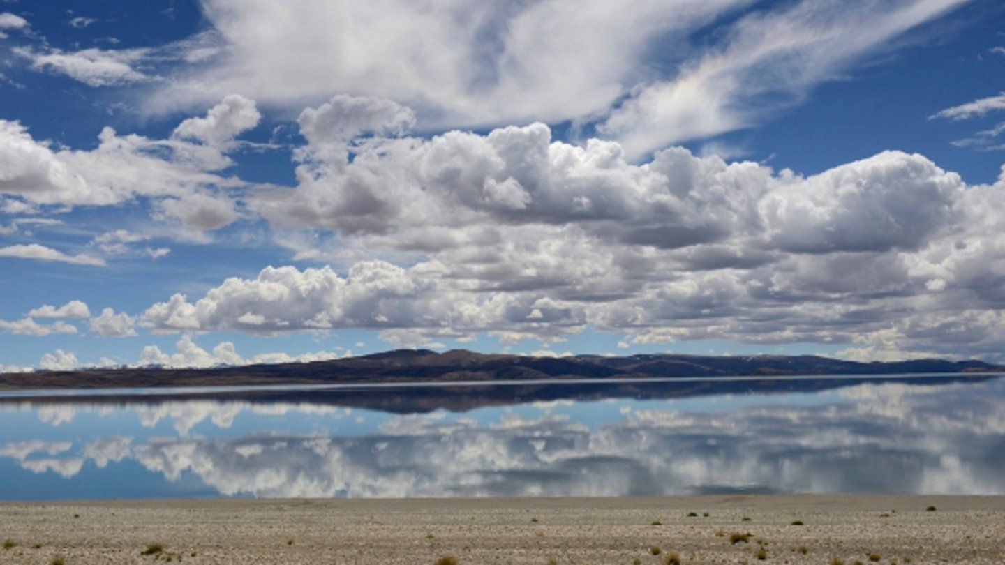 Clouds reflected in still water. Programme still.