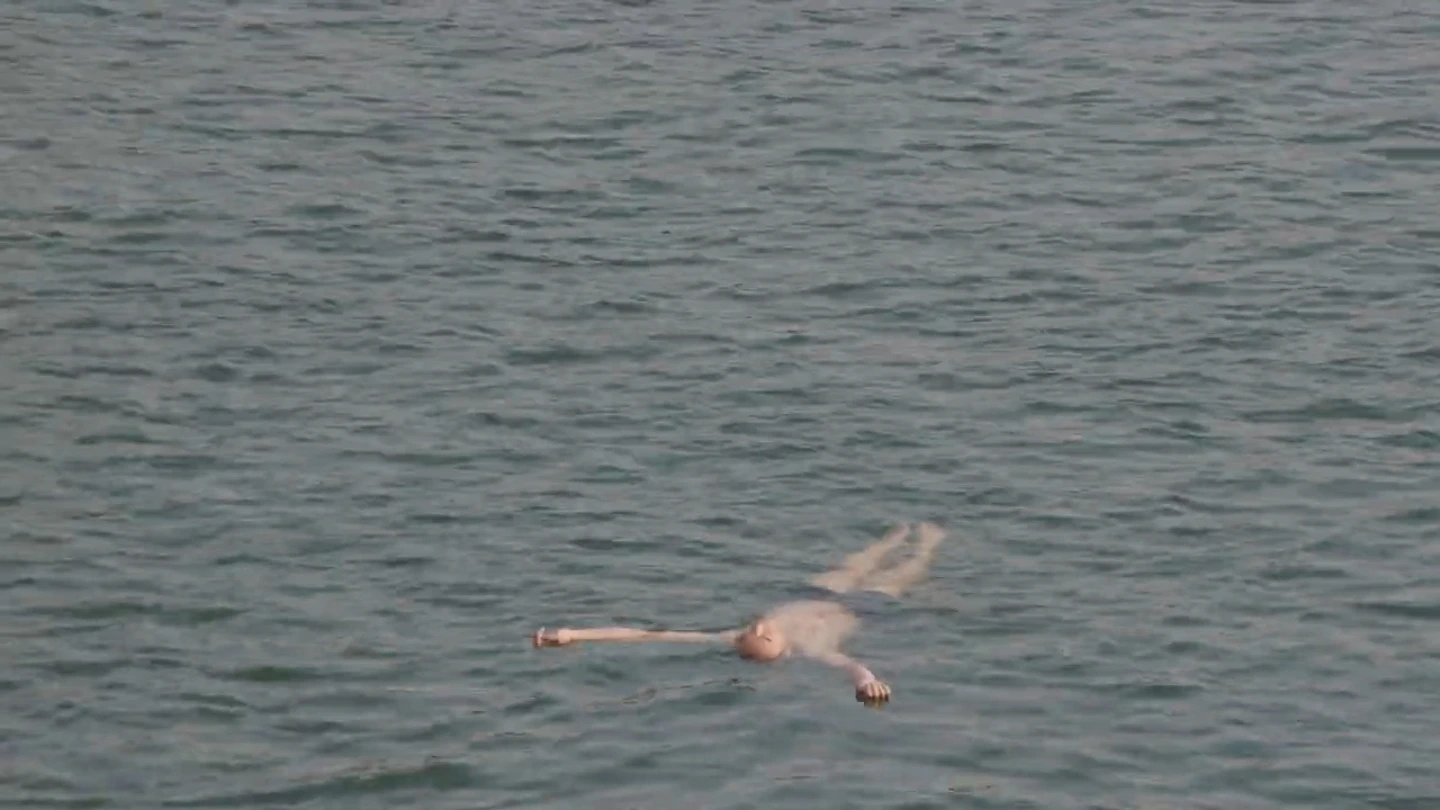A swimmer floating on the surface of the water.