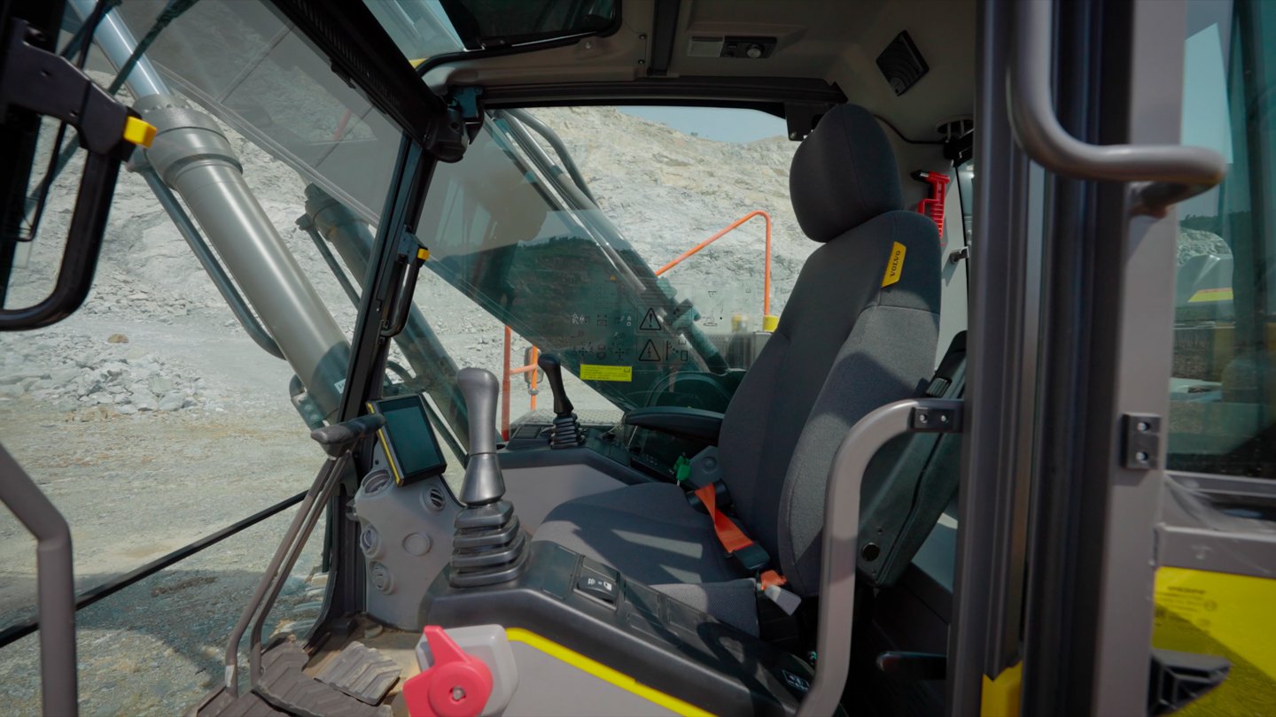 Wide interior view of the Volvo EC360 operator cab prepared for filming