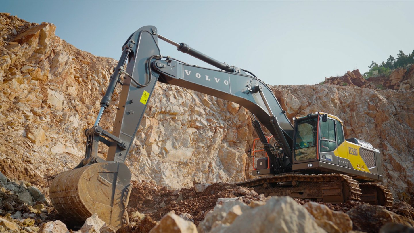 Volvo EC360 excavator framed against the terraced limestone mine