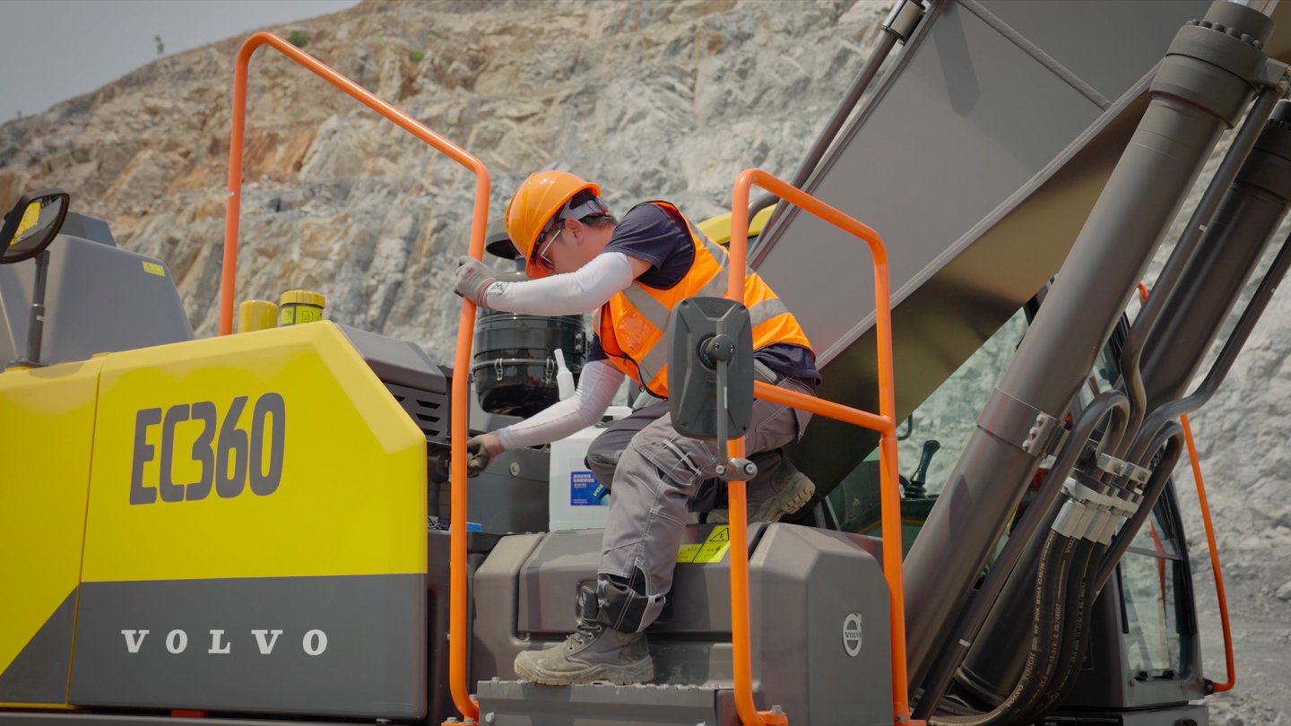 Operator inspecting the Volvo EC360 excavator before filming