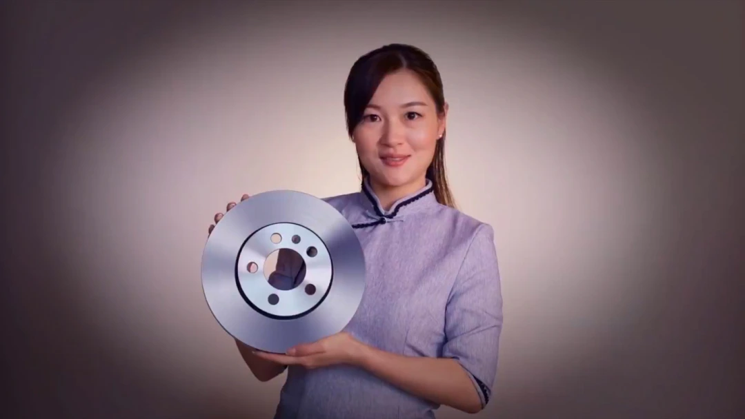 Woman holding a TRW brake disc in a staged campaign shot