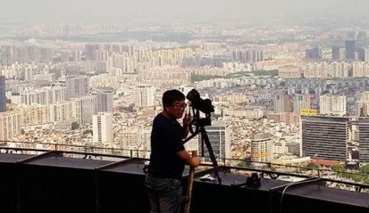 videographer on ladder