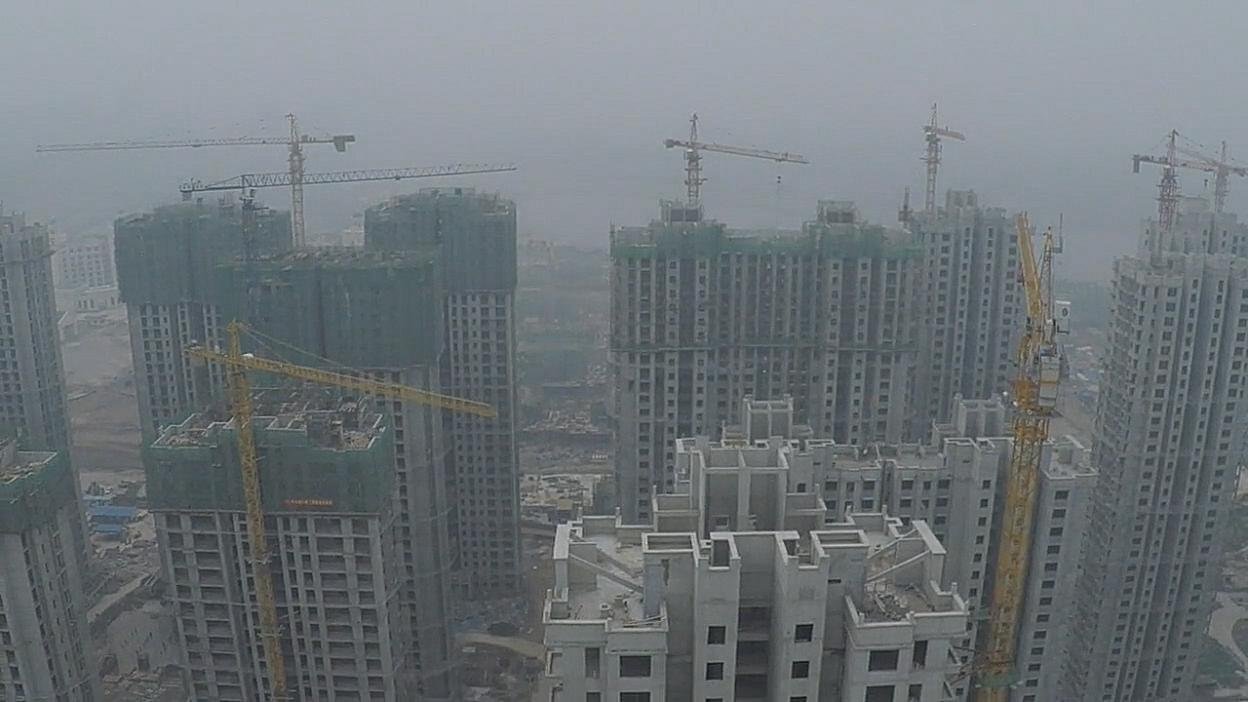 High-rise construction seen through haze. Film still.