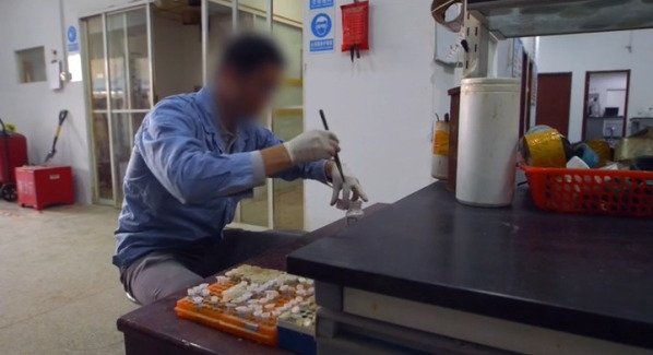 Researchers working in a drug lab in China, focusing on pharmaceutical development.