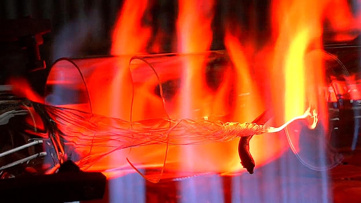 Glass being worked in a flame. Film still.