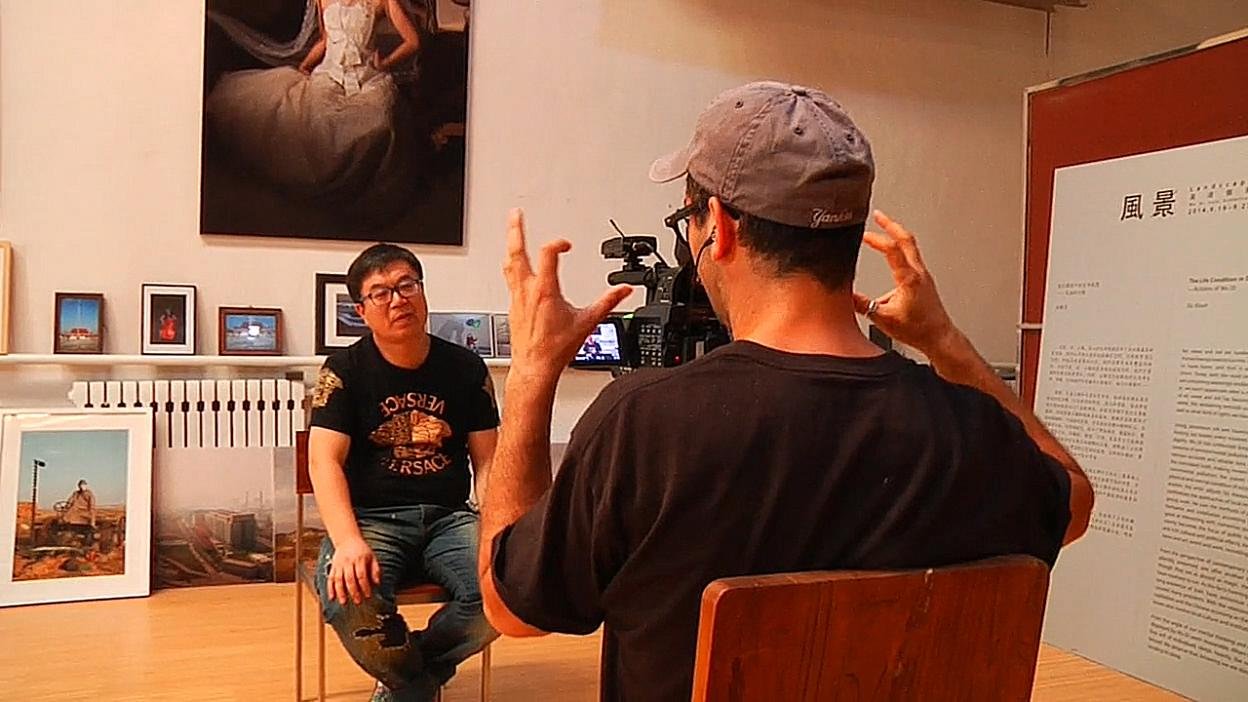 Filming an interview in an art-filled room. An image from the China production.