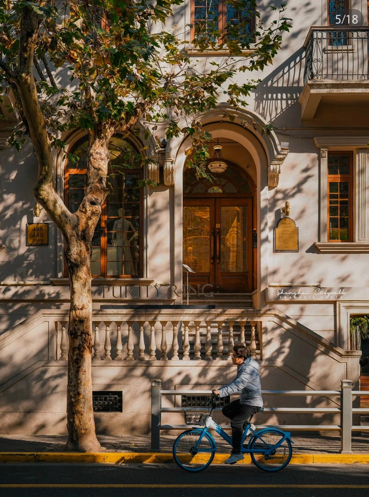 A cyclist passes by a historic building in Shanghai's French Concession, an area rich in heritage and cinematic appeal.
