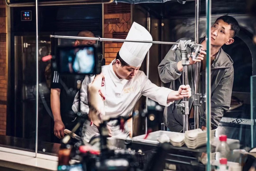 Chef preparing food on set during a cooking video shoot