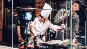Chef preparing food on set during a cooking video shoot