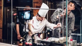 Chef preparing food on set during a cooking video shoot