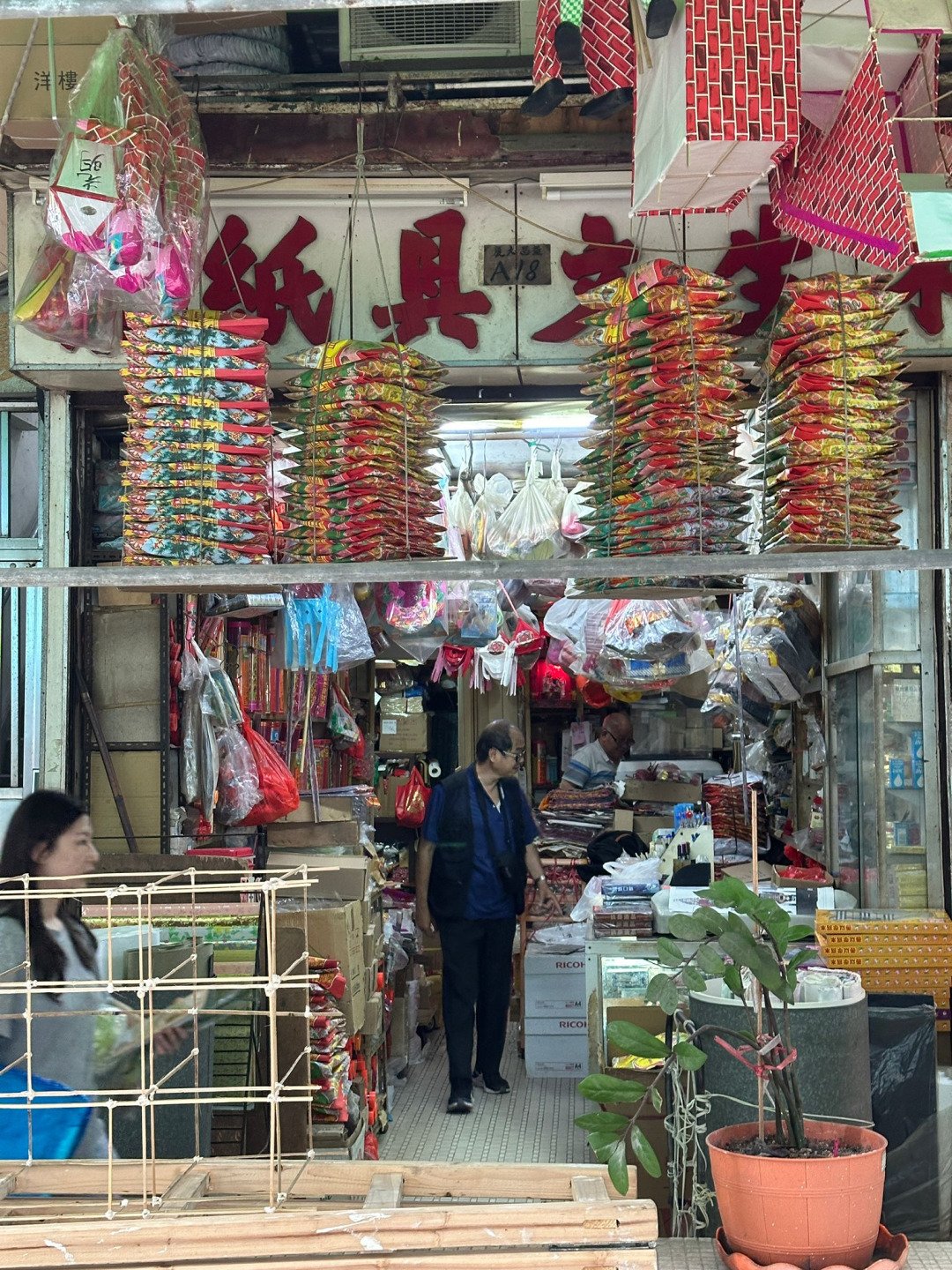 Traditional joss paper shop run by elderly owner in Monster Building – ideal for cultural video storytelling