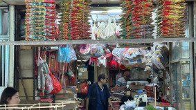 Traditional joss paper shop run by elderly owner in Monster Building – ideal for cultural video storytelling