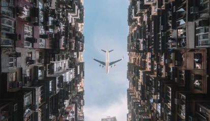 Courtyard of Monster Building with airplane overhead – cinematic Hong Kong video shoot location