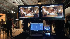 Video shooting fixer China monitoring footage on three screens during a shoot