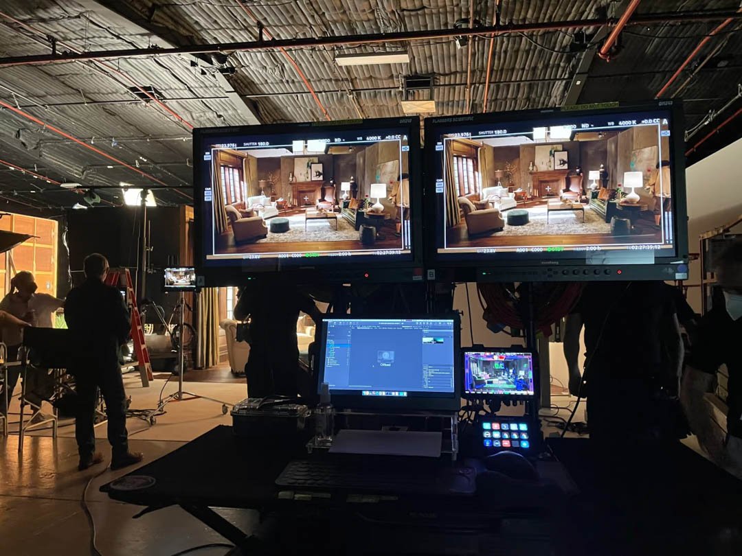 Video shooting fixer China monitoring footage on three screens during a shoot