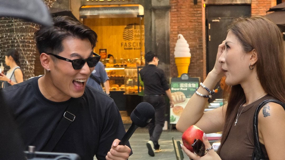 Host interviews woman about Apple brand in Shanghai Xintiandi with Alchemist Films providing bilingual translation and cultural support