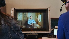 Client and U.S. director reviewing interview footage on monitor, supported by Alchemist Films — leading China video production fixer for international clients