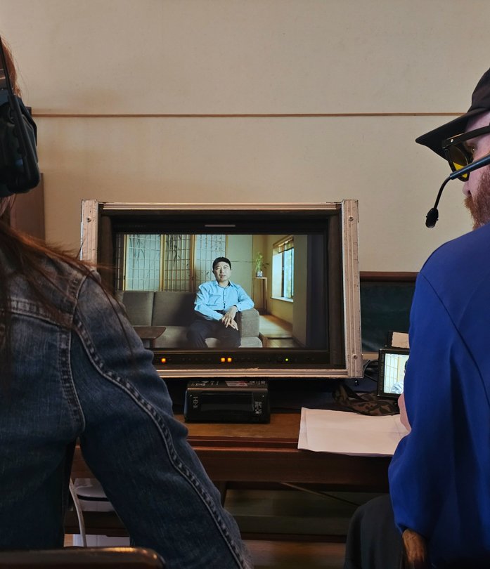 Client and U.S. director reviewing interview footage on monitor, supported by Alchemist Films — leading China video production fixer for international clients